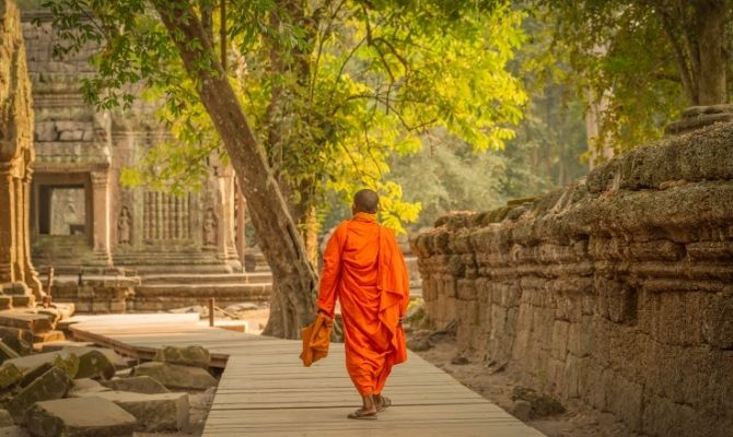 Monk walking through Ta Prohm, Siem Reap, Cambodia