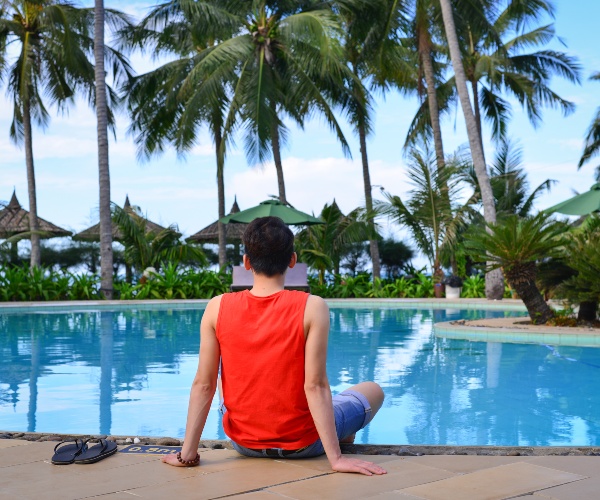 Tourist by hotel pool in Mui Ne