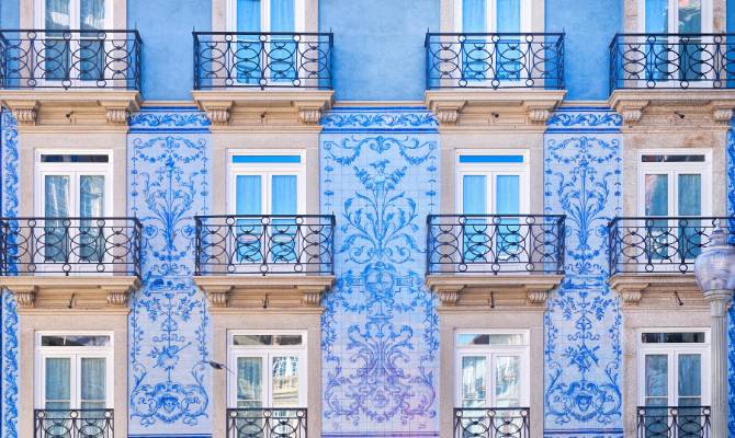 Traditional architecture of buildings with tiles in Porto Portugal Blue facades with windows and balcony 670x400